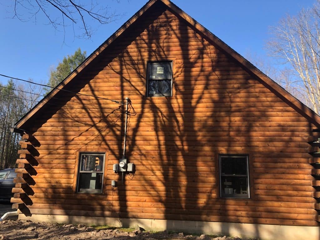 large wood home with three windows